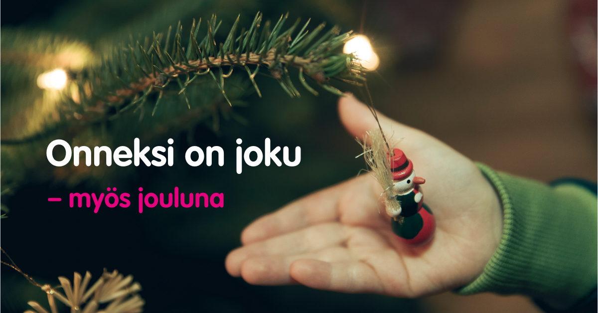 Kuusenoksassa olevaa joulukoristetta pitelevä käsi, jonka vieressä teksti Onneksi on joku - myös jouluna.